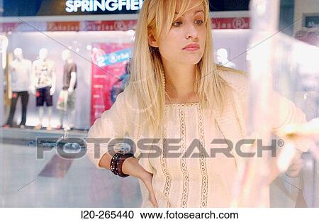 Woman in shopping center, looking at shop windows View Large Photo Image Stock Image - Woman in shopping center, looking at shop windows. Fotosearch
