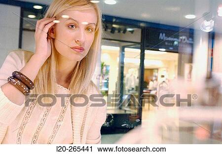Woman in shopping center, looking at shop windows View Large Photo Image Stock Image - Woman in shopping center, looking at shop windows. Fotosearch