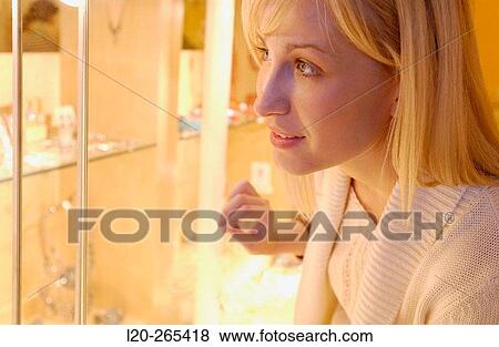 Woman in shopping center, looking at jewelry View Large Photo Image Stock Photo - Woman in shopping center, looking at jewelry. Fotosearch