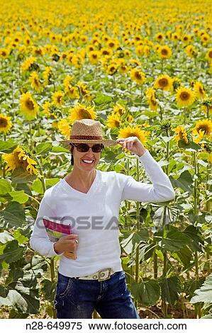 Woman in sunflower field View Large Photo Image Stock Photography - Woman in sunflower field. Fotosearch