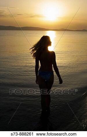Woman in the beach during the sunset, Naxos, Cyclades Islands, Greece, Europe View Large Photo Image Stock Image - Woman in the beach during the sunset, Naxos, Cyclades Islands, Greece, Europe. Fotosearch