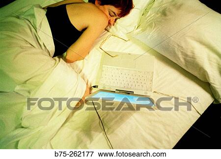 Woman in the bed with laptop View Large Photo Image Stock Photo - Woman in the bed with laptop. Fotosearch