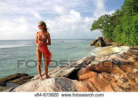 Stock Image - Woman in the paradise of Saint Anne in Seychelles Islands.. Fotosearch