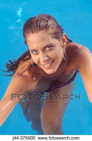 Stock Image - Woman in the pool smiling. Fotosearch