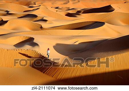 Woman in the sand dunes of the empty quarter desert. United Arab Emirates, UAE, Abu Dhabi, Liwa Oasis, Moreeb Hill, Tal Mireb. Model Released. View Large Photo Image Picture - Woman in the sand dunes of the empty quarter desert. United Arab Emirates, UAE, Abu Dhabi, Liwa Oasis, Moreeb Hill, Tal Mireb. Model Released.. Fotosearch