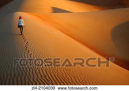 Woman in the sand dunes of the empty quarter desert. United Arab Emirates, UAE, Abu Dhabi, Liwa Oasis, Moreeb Hill, Tal Mireb. Model Released. View Large Photo Image Stock Photo - Woman in the sand dunes of the empty quarter desert. United Arab Emirates, UAE, Abu Dhabi, Liwa Oasis, Moreeb Hill, Tal Mireb. Model Released.. Fotosearch