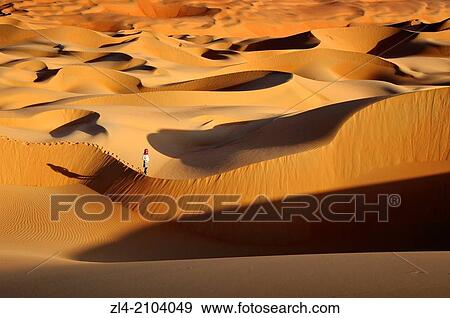 Woman in the sand dunes of the empty quarter desert. United Arab Emirates, UAE, Abu Dhabi, Liwa Oasis, Moreeb Hill, Tal Mireb. Model Released. View Large Photo Image Stock Photo - Woman in the sand dunes of the empty quarter desert. United Arab Emirates, UAE, Abu Dhabi, Liwa Oasis, Moreeb Hill, Tal Mireb. Model Released.. Fotosearch