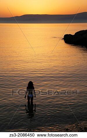 Stock Image - Woman in the sea, Koufonissi, Cyclades Islands, Greek Islands, Greece, Europe.. Fotosearch