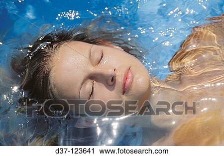 Stock Image - Woman in the swimming pool. Fotosearch