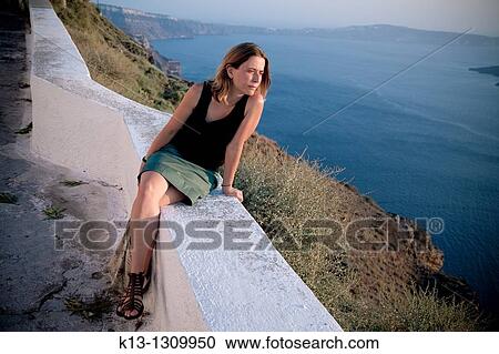 Stock Image - Woman in Thira Santorini, Cyclades Islands, Greece. Fotosearch
