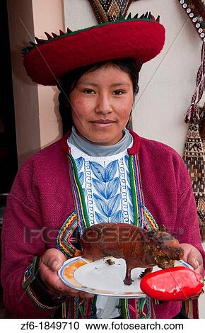 Woman in traditional clothes holding guinea pig dinner local farm dinner near Cusco Cuzco Peru View Large Photo Image Stock Image - Woman in traditional clothes holding guinea pig dinner local farm dinner near Cusco Cuzco Peru. Fotosearch