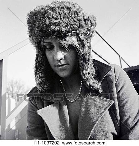 Woman in ushanka and coat, looking down View Large Photo Image Stock Image - Woman in ushanka and coat, looking down. Fotosearch