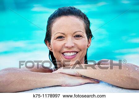 Woman in water resting at the edge of the pool View Large Photo Image Stock Photo - Woman in water resting at the edge of the pool. Fotosearch