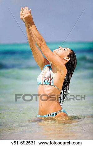 Woman in water splashing, eyes closed View Large Photo Image Stock Image - Woman in water splashing, eyes closed. Fotosearch