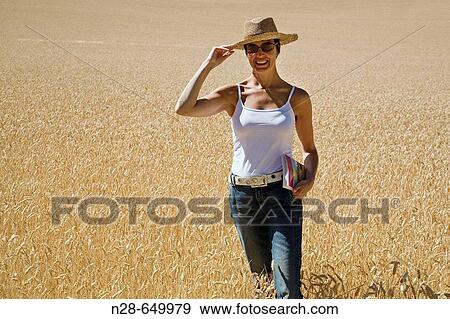 Stock Photo - Woman in wheat field. Fotosearch