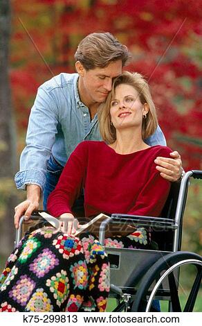 Woman in wheelchair getting a hug View Large Photo Image Stock Image - Woman in wheelchair getting a hug. Fotosearch
