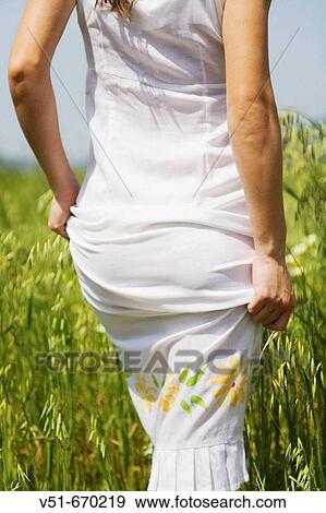 Woman in white dress in the countryside View Large Photo Image Stock Photo - Woman in white dress in the countryside. Fotosearch