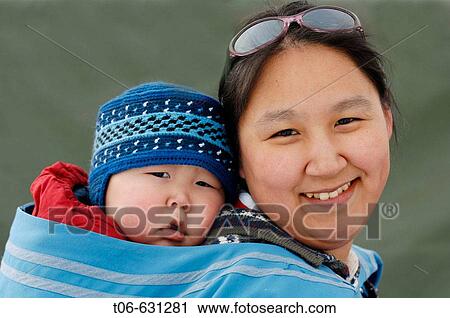 Woman Inuit carrying child in Nord West Territories, Canada View Large Photo Image Stock Image - Woman Inuit carrying child in Nord West Territories, Canada. Fotosearch