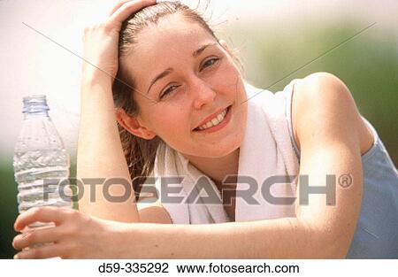 Stock Image - Woman jogger sitting down taking break. Fotosearch