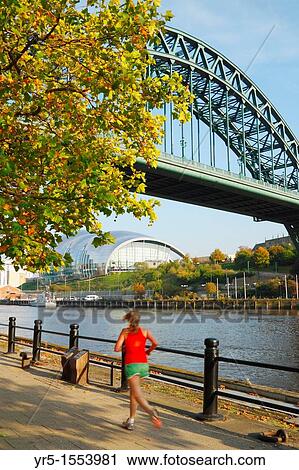 Woman jogging along Quayside under The Tyne bridge Gateshead Sage concert hall in distance Newcastle upon Tyne, England, United Kingdom View Large Photo Image Stock Image - Woman jogging along Quayside under The Tyne bridge Gateshead Sage concert hall in distance Newcastle upon Tyne, England, United Kingdom. Fotosearch