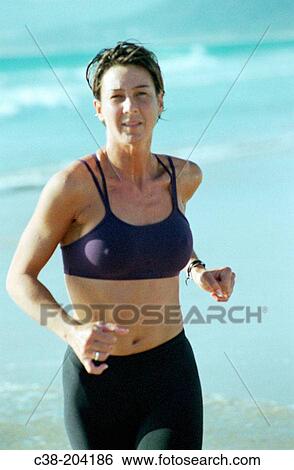 Woman jogging View Large Photo Image Stock Photograph - Woman jogging. Fotosearch