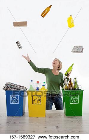 Woman juggling recyclable waste View Large Photo Image Stock Photo - Woman juggling recyclable waste. Fotosearch