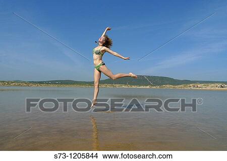 Woman jumping in Caos de Meca, CBdiz, Andaluc? a, Spain View Large Photo Image Picture - Woman jumping in Caos de Meca, CBdiz, Andaluc? a, Spain. Fotosearch