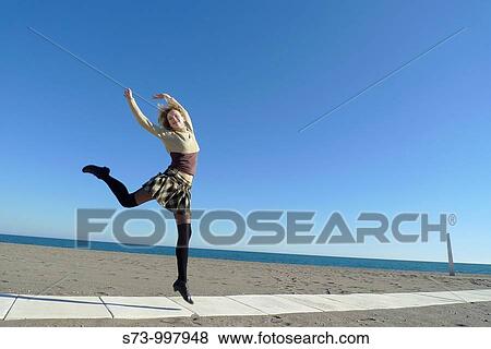 Woman jumping in Torremolinos beach, Malaga province, Andalusia, Spain View Large Photo Image Stock Photo - Woman jumping in Torremolinos beach, Malaga province, Andalusia, Spain. Fotosearch