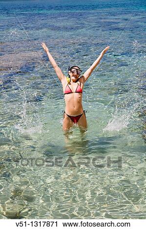 Woman jumping in water with snorkel gear View Large Photo Image Stock Image - Woman jumping in water with snorkel gear. Fotosearch