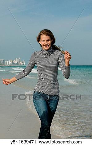 woman jumping next to seaside View Large Photo Image Stock Image - woman jumping next to seaside. Fotosearch