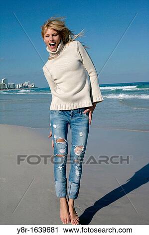 woman jumping next to seaside View Large Photo Image Stock Image - woman jumping next to seaside. Fotosearch