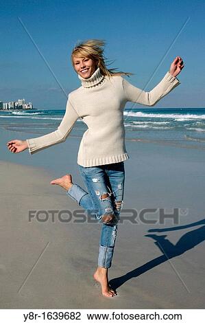 woman jumping next to seaside View Large Photo Image Stock Image - woman jumping next to seaside. Fotosearch