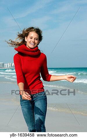 Stock Photo - woman jumping next to seaside. Fotosearch