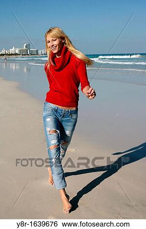 Stock Photograph - woman jumping next to seaside. Fotosearch
