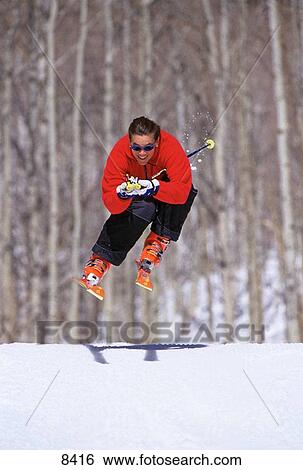 Woman jumping over small hill View Large Photo Image Stock Photograph - Woman jumping over small hill. Fotosearch