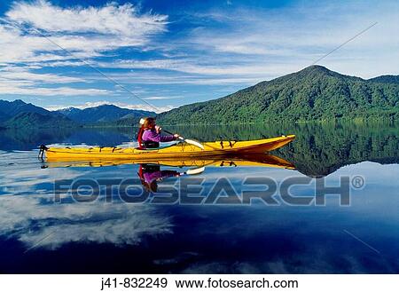 Woman kayaker on Lake Kaniere West Coast New Zealand View Large Photo Image Stock Photo - Woman kayaker on Lake Kaniere West Coast New Zealand. Fotosearch