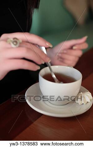 Stock Image - woman keeping the cup in the hand casual coffee cute drink. Fotosearch