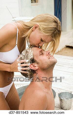 Stock Image - Woman kissing a man tenderly. Fotosearch