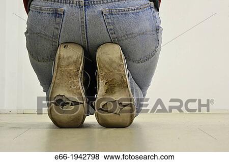 woman kneeling, sitting on feet, wearing worn out sneakers View Large Photo Image Stock Photo - woman kneeling, sitting on feet, wearing worn out sneakers. Fotosearch