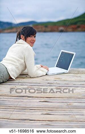 Woman, laptop, communications, seaside, young adult View Large Photo Image Stock Photograph - Woman, laptop, communications, seaside, young adult. Fotosearch