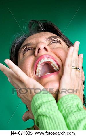 Woman laughing with hands on face, looking up, Close-up View Large Photo Image Stock Photography - Woman laughing with hands on face, looking up, Close-up. Fotosearch