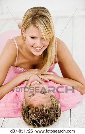 Woman laying on a man tenderly View Large Photo Image Stock Photograph - Woman laying on a man tenderly. Fotosearch