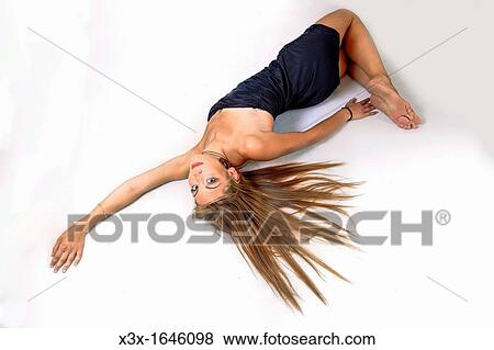 Woman laying on the floor View Large Photo Image Stock Photo - Woman laying on the floor. Fotosearch