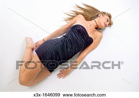 Woman Laying On The Floor Stock Photo X3x Fotosearch