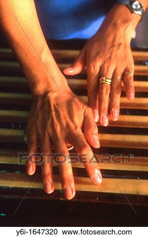 Woman laying out confectionery strips used to make handmade coconut sweets Mekong Delta Vietnam View Large Photo Image Stock Image - Woman laying out confectionery strips used to make handmade coconut sweets Mekong Delta Vietnam. Fotosearch