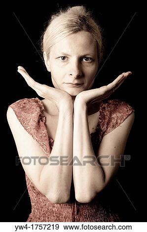 Stock Photo - Woman leaning her chin on her palms. Fotosearch