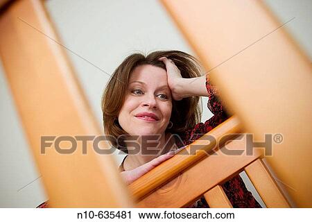 Woman leaning on a baby's crib View Large Photo Image Stock Image - Woman leaning on a baby's crib. Fotosearch