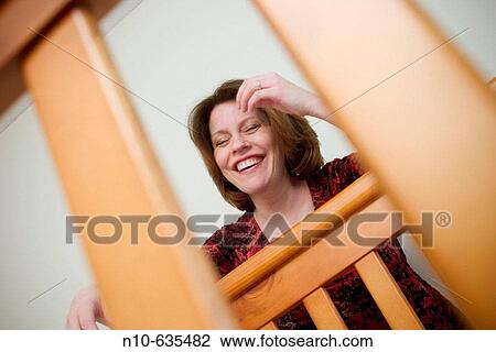 Woman leaning on a baby's crib View Large Photo Image Stock Image - Woman leaning on a baby's crib. Fotosearch