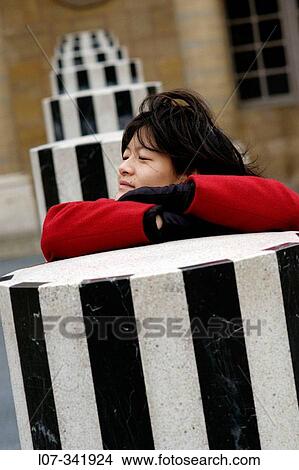 Woman leaning on sculpture in the courtyard of the Palais-Royal. Paris. France View Large Photo Image Picture - Woman leaning on sculpture in the courtyard of the Palais-Royal. Paris. France. Fotosearch