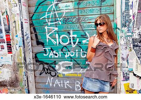 Woman leaning on store graffiti View Large Photo Image Stock Image - Woman leaning on store graffiti. Fotosearch
